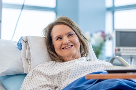 Woman smiling in her hospital bed