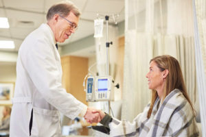 Doctor at an infusion chair with patient
