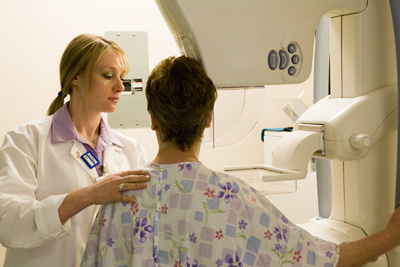 patient undergoing mammogram with technician
