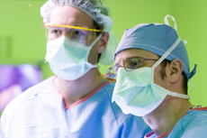 Lahey surgeons wearing scrubs and face masks